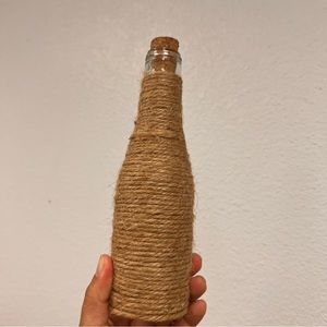 miniature wine bottle wrapped with twine